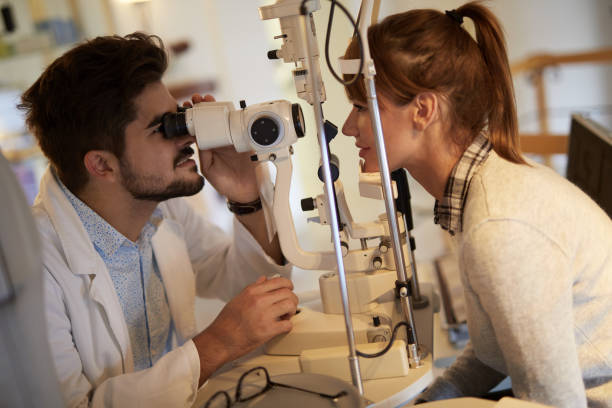 istock Young woman having her eyes examined by optometrist 1372566085