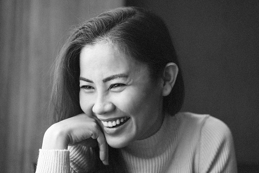 Portrait of Asian woman smiling - black and white