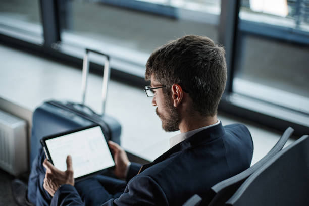 istock thoughtful businessman with a digital tablet waiting for his flight 1372567953