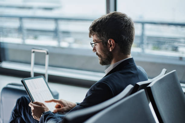 istock businessman works on a digital tablet, sitting on a bench in the 1372568008
