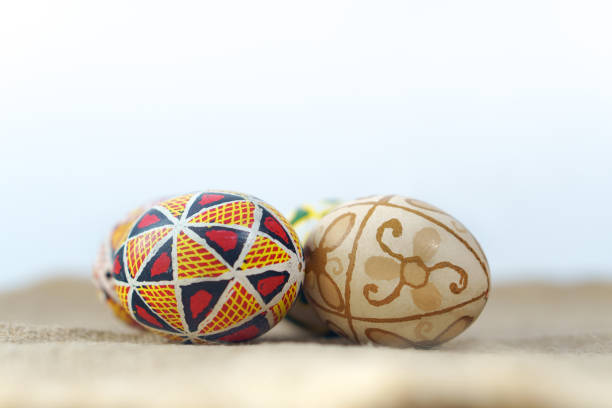 Close-up of painted eggs on linen fabric. Traditional ornament. Happy Easter.