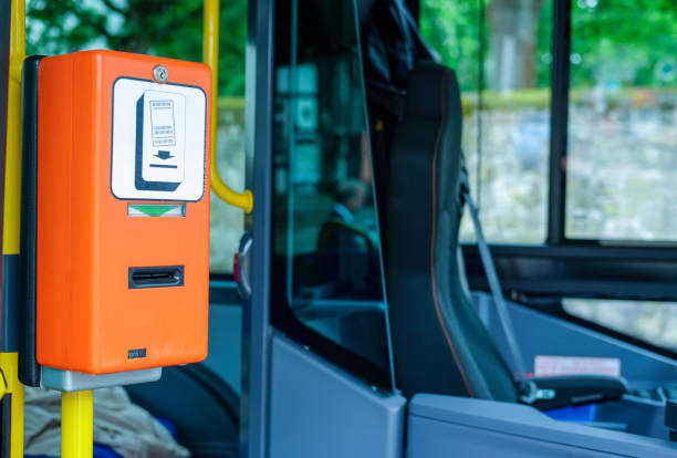 Close-up of a orange ticket validator in a public bus next to the driver's seat, selective focus Close-up of a ticket validator in a public bus, blurred background with plenty of copyspace, side view, selective focus, no people cash in transit vehicle stock pictures, royalty-free photos & images