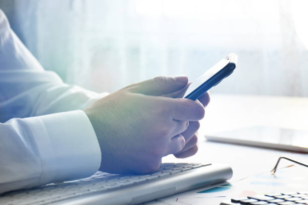 istock Business person using smart phone at the office 1372577602