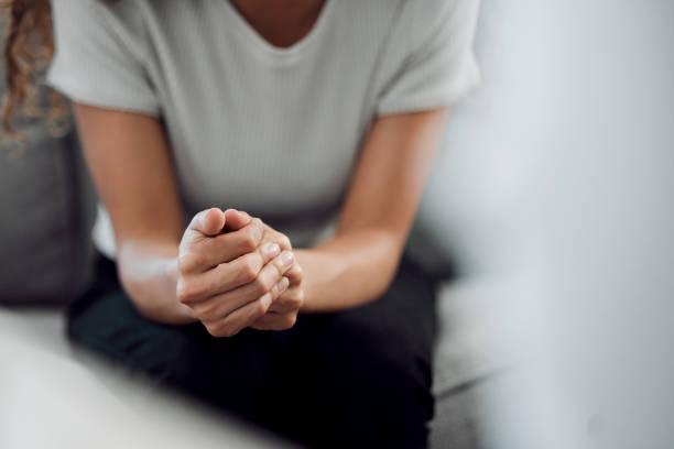 Cropped shot of an unrecognisable woman sitting alone and feeling anxious during her consultation Can we start this session now? alcoholics anonymous photos stock pictures, royalty-free photos & images