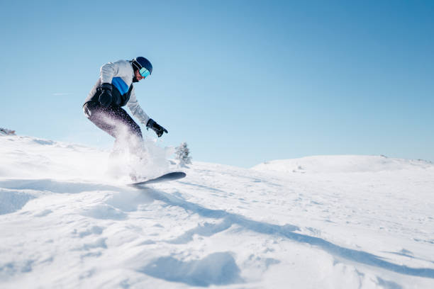 istock Snowboarder is sliding with snowboard 1372579258