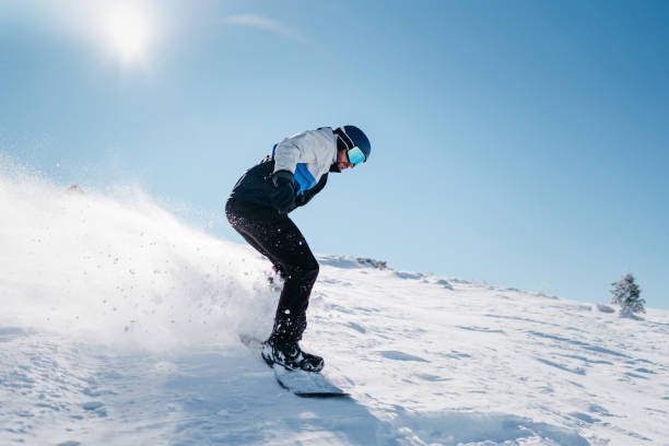 istock Snowboarder is sliding with snowboard 1372579280