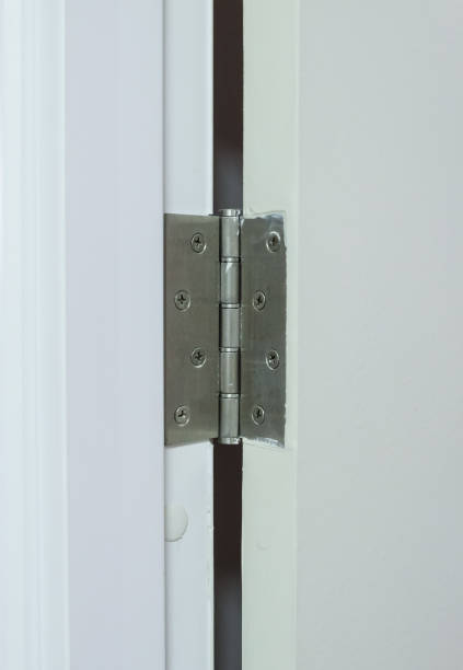 closeup of the metal hinges on the white pvc door. - 合頁 個照片及圖片檔