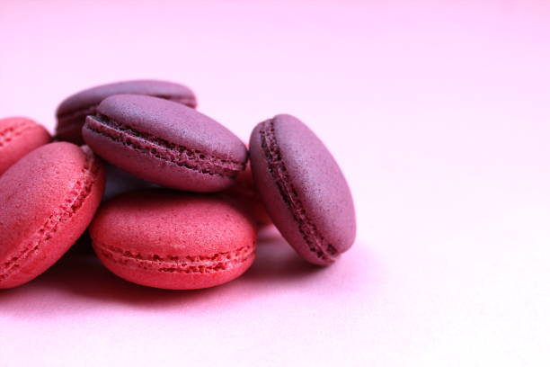 istock Heap of macaroon cookies on a pink background. 1372580473