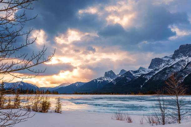 istock Sunlit Clouds Over Snowy Mountains And Lake 1372581401