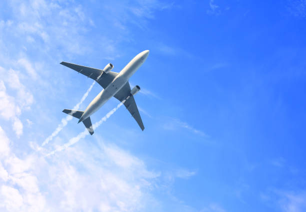 horizontal nature background with aircraft and jet trailing smoke in the sky. airplane and condensation trail - jet imagens e fotografias de stock