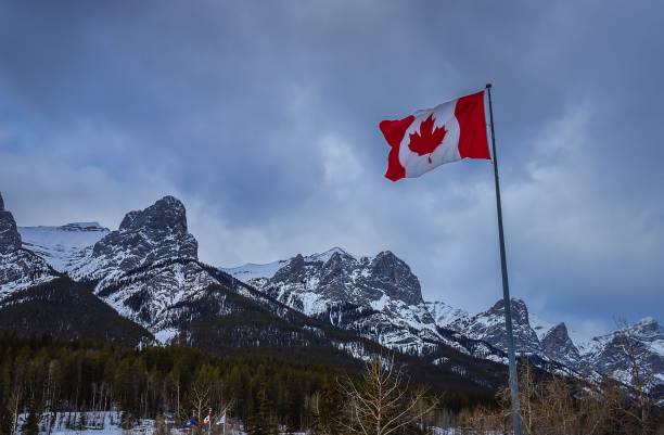 istock Canadian Flag In The Mountains 1372582091