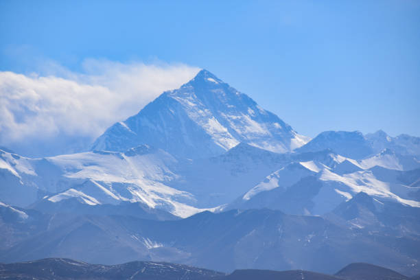 The endless asphalt road at the foot of the snowcapped mountain