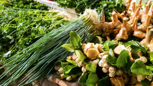 istock Ginger, galangal, lemongrass, coriander, kaffir lime leaves, spring onion Assorted fresh vegetables on the table for sale in the fresh vegetable market. 1372583076