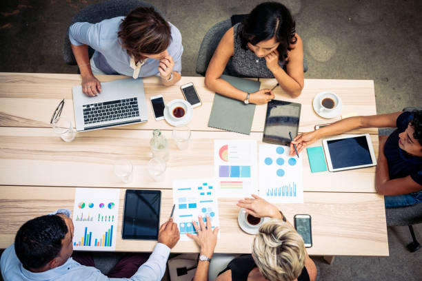 istock Overhead view of diverse business people working in office 1372584212
