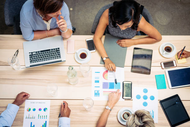 istock Overhead view of diverse business people working in office 1372584256