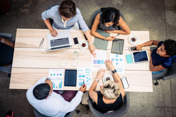 istock Overhead view of diverse business people working in office 1372584262