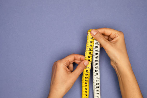 istock Woman Holding Tape Measure 1372584542