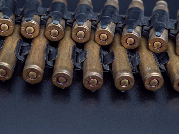 istock Cartridges from a machine gun on a black background 1372584613