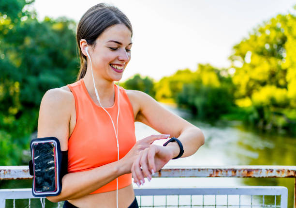 istock Female runner looking at smart watch 1372584690