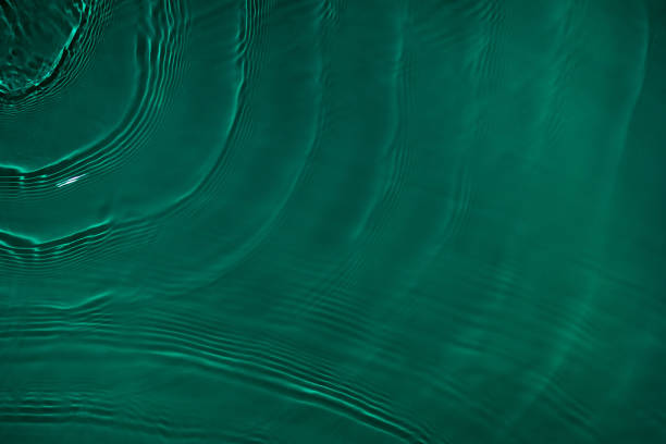 istock transparent dark green colored clear calm water surface texture 1372584740