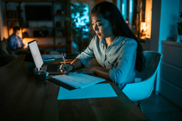 istock Young asian woman finishing work project before deadline 1372587543
