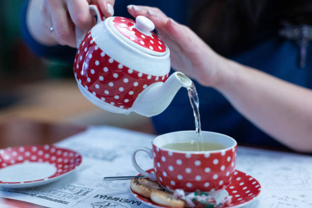 istock A woman pours green tea into a cup 1372588588
