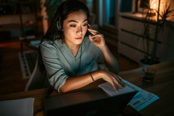 istock Woman working night shift in call center 1372588712