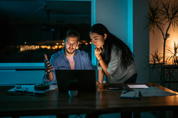 istock Colleagues working late at night in the office. 1372588755