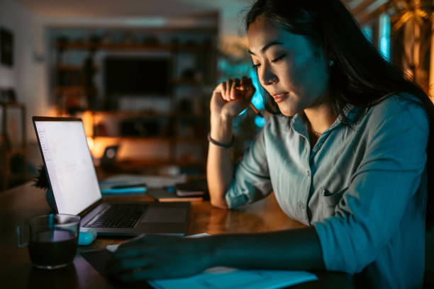 istock Young asian woman finishing work project before deadline 1372588820