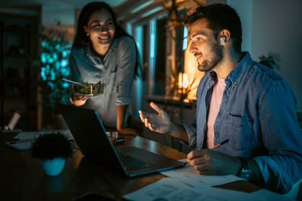 istock Mid adult couple at home, having dinner while doing home finances. 1372588838