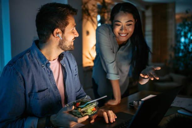 istock Mid adult couple at home, having dinner while doing home finances. 1372588870
