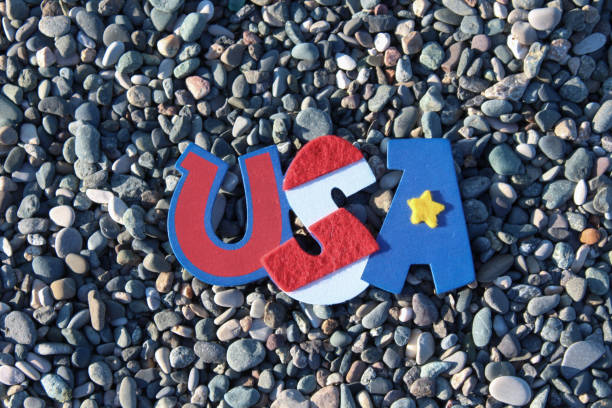 istock USA small symbolic flag on a rocky background 1372590225