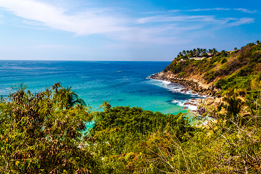 Beach with turquoise sea and ravines on the coast on a sunny day in Carrizalillo Puerto Escondido Oaxaca