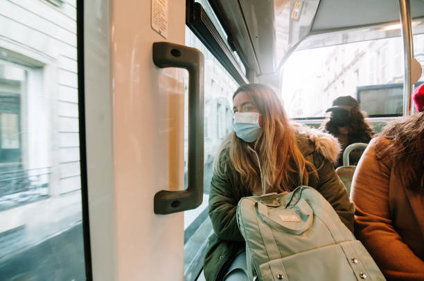 istock Young woman with face mask on a bus 1372592374