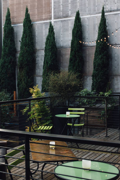 istock Outdoor deck, patio with green cafe tables before a party 1372593986