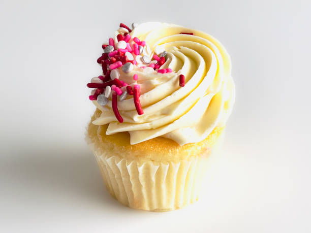 istock Vanilla cupcake with frosting and sprinkles 1372594129