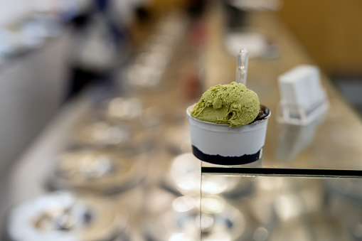 artisanal ice cream in eco natural paper cup with transparent spoon on top