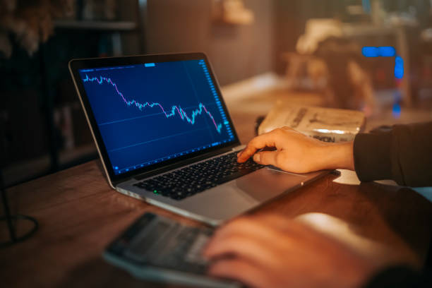 istock computer and a hand showing crypto stock market chart 1372599169