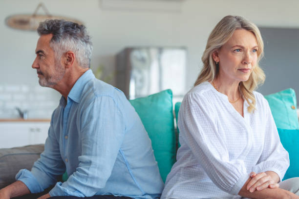 istock Mature couple fighting at home sitting on the sofa. 1372599337