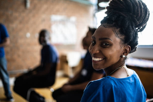 Portrait of a young woman in a meeting at a community center Portrait of a young woman in a meeting at a community center black woman hair bun stock pictures, royalty-free photos & images