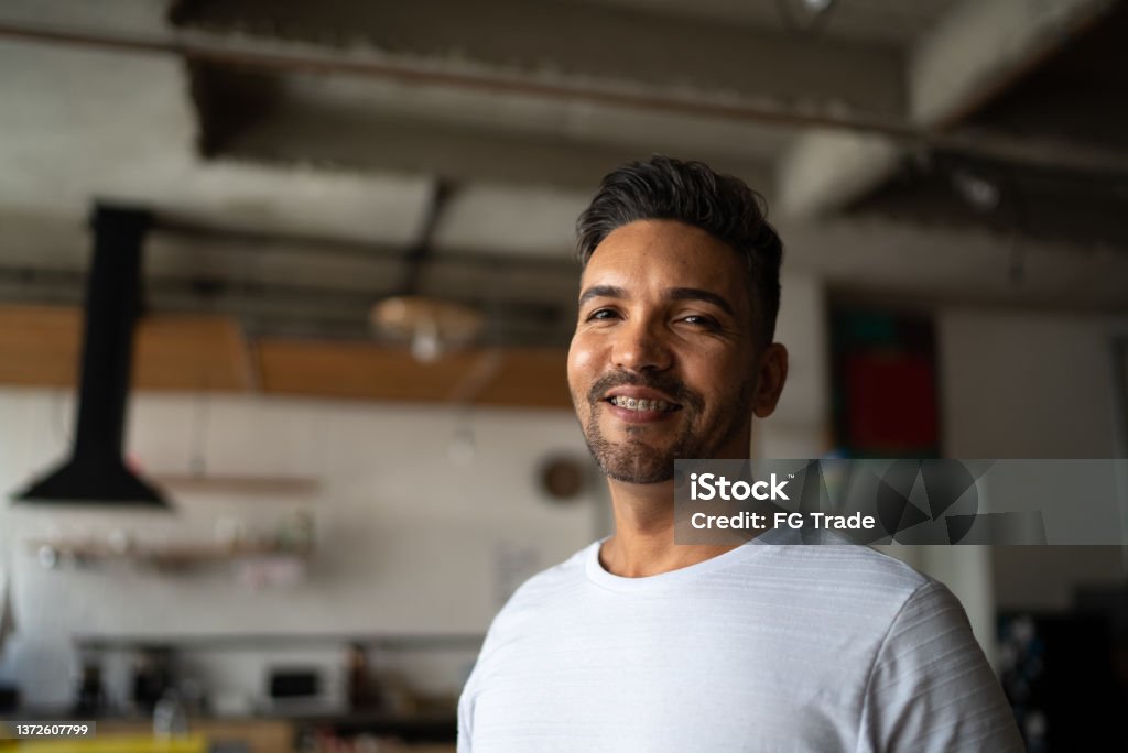 Portrait of a mid adult man at home Dental Braces Stock Photo