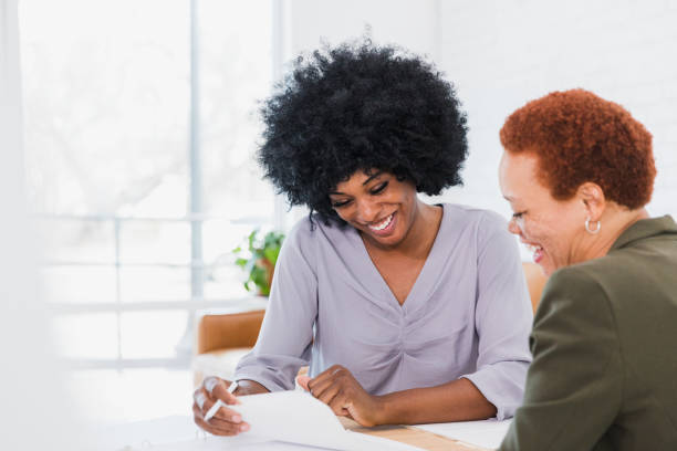 istock Sitting in their office, female colleagues discuss project 1372613395