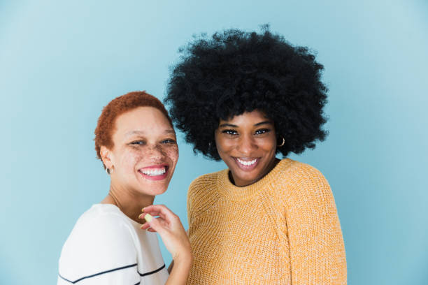 istock Posing in front of a blue background, models smile for camera 1372613418
