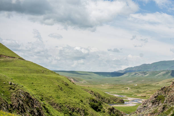 istock Rocky Mountains. mountain river on a background of blue sky 1372613923
