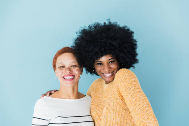 istock Two joyful women look at camera and smile 1372615433