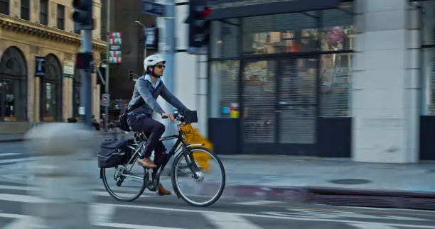 A middle aged man cycling to work on an e-bike in Downtown Los Angeles.