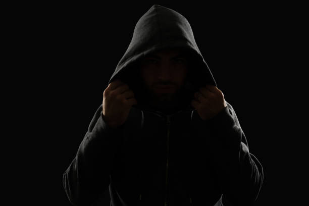 istock Thief in a hood hiding his face 1372620040