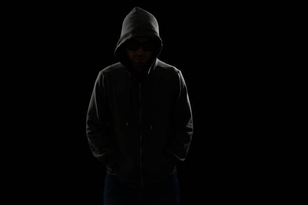istock Unrecognizable criminal in the dark 1372620074