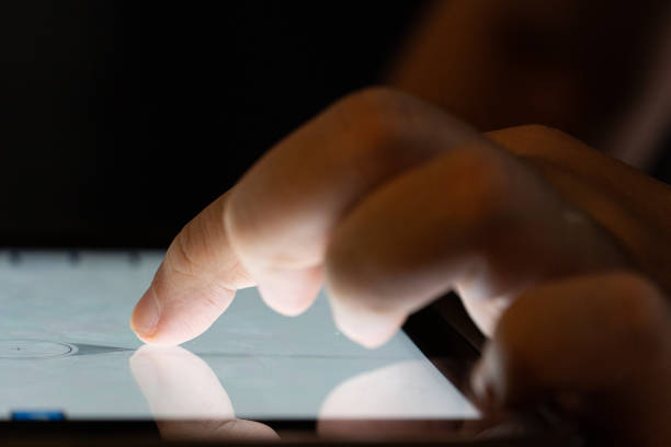 istock Finger touch on Tablet screen Mock up with light. Concept for mobile phone technology and technology. 1372625288