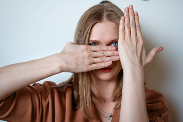 istock woman covers her face with her hands 1372625330